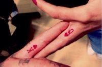 king and queen heart tattoos in red on the side of ring fingers are lovely and very cool
