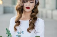 long vintage waves accented with a birdcage veil and a burgundy lip look very elegant and vintage-inspired