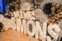 marquee letters portraying the last name and lots of balloons are amazing to style your wedding venue