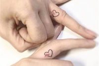 matching heart tattoos with heartbeat made on the sides of the ring fingers are lovely and very cute