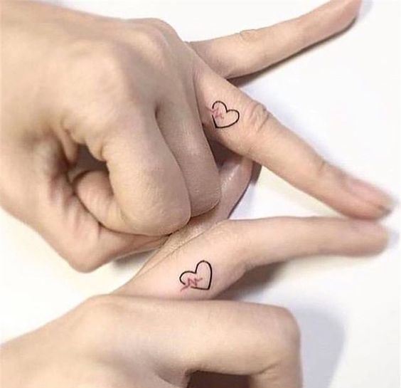matching heart tattoos with heartbeat made on the sides of the ring fingers are lovely and very cute