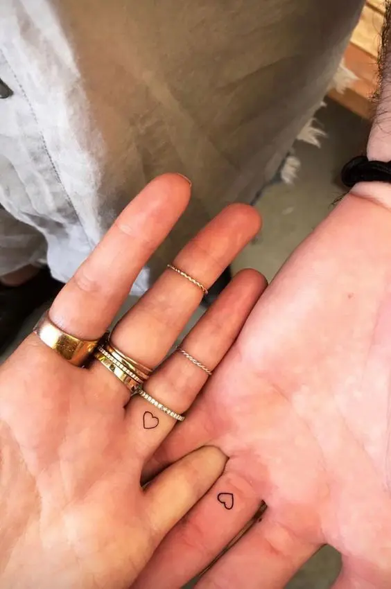 mini heart tattoos on the backs of the ring fingers are great for a modern couple and they aren't in your face