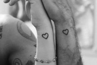 simple heart silhouette tattoos on the wrists are timeless and stylish, you can rock them in any color