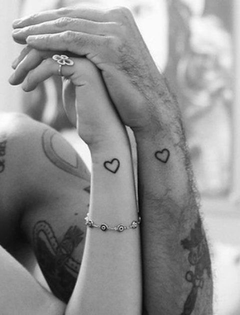 simple heart silhouette tattoos on the wrists are timeless and stylish, you can rock them in any color
