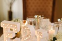 small white marquee monograms and an ampersand are great to decorate a wedding sweetheart table, add blooms