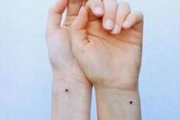 tiny black heart tattoos on the wrists are amazing to commemorate your wedding date