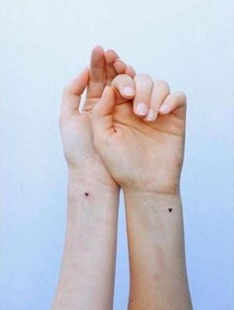 tiny black heart tattoos on the wrists are amazing to commemorate your wedding date