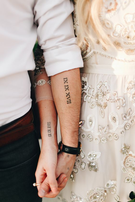 wedding date tattoos done with Roman numbers and placed on arms is a stylish idea