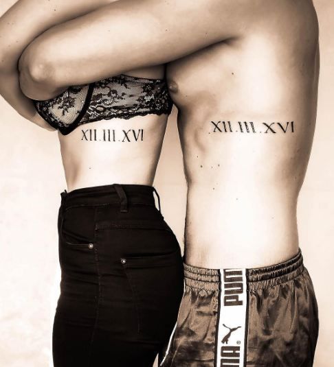 wedding date tattoos placed on the sides and done with Roman numbers is a creative idea