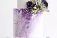 a beautiful and glam white and lilac watercolor wedding cake with silver leaf, purple and lilac blooms and succulents is a fantastic idea for a spring or summer wedding