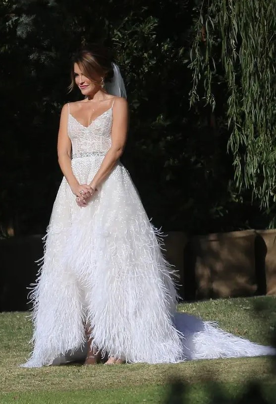 a beautiful glam A line wedding dress with a V neckline, a feather skirt with a train and embellishments is a fantastic idea