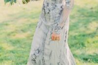 a blue embellished wedding dress with sheer long sleeves and an illusion neckline is your something blue at the wedding