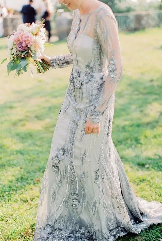 a blue embellished wedding dress with sheer long sleeves and an illusion neckline is your something blue at the wedding