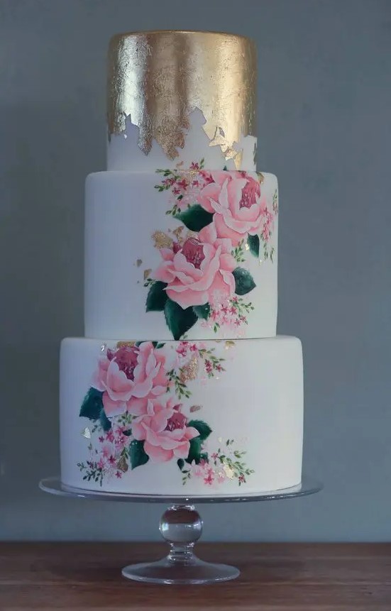 a bold and chic wedding cake with a top gold foil tier and two beautiful handpainted ones plus gold foil touches