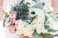 a bouquet with neutral and pink roses, anemones and blue thistles for a spring bride