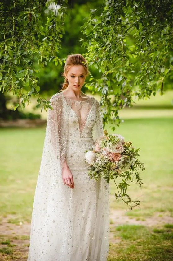 a breathtaking embellished sheath wedding dress with a covered plunging neckline plus a matching capelet