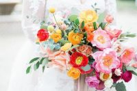 a bright wedding bouquet of yellow, red and pink blooms plus ribbons is great for rocking it at a colorful wedding