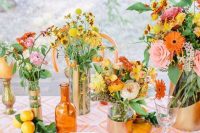 a colorful summer wedding tablescape with a bright printed table runner, bold blooms and greenery, colorful porcelain and yellow cutlery