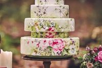 a creative hand painted wedding cake done of different tiers to make it catchy and even whimsy