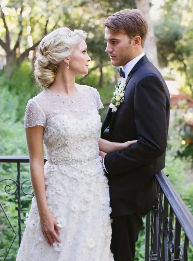 a cute floral lace applique and embellishments wedding dress with short sleeves and an illusion neckline