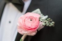a delicate and chic pink ranunculus and greenery boutonniere is a delicate and sutble touch of color to your outfit