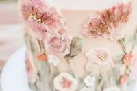 a delicate blush wedding cake with sugar pink blooms and foliage is a gorgeous idea for a pastel spring wedding