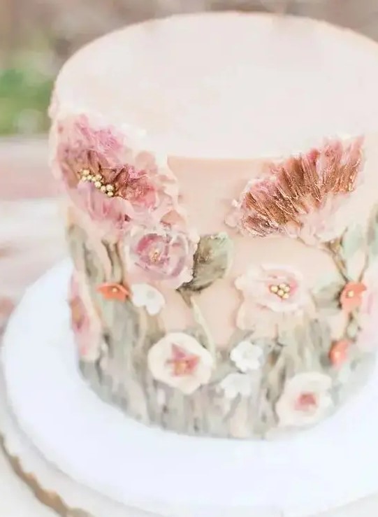 a delicate blush wedding cake with sugar pink blooms and foliage is a gorgeous idea for a pastel spring wedding