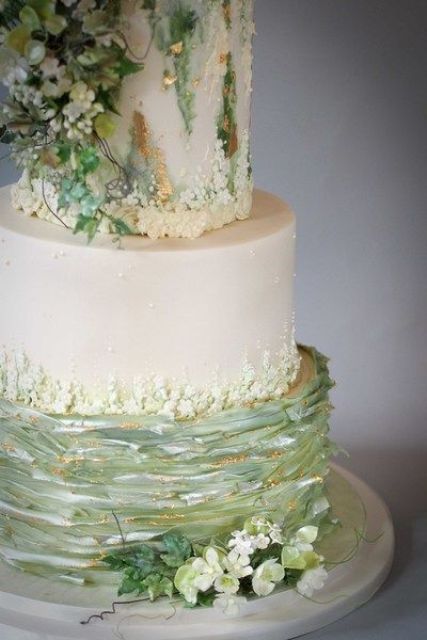 a fabulous wedding cake with white and green tiers, with touches og gold and sugar blooms and leaves is a masterpiece