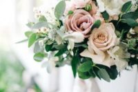 a fresh spring wedding bouquet with pink and white blooms and greenery and much texture