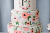 a fun handpainted wedding cake in bold coral with a primitivist touch, a large monogram on the top tier