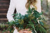 a gorgeous white fully embellished wedding dress with long sleeves and a high neckline, a textural and bold greenery wedding bouquet