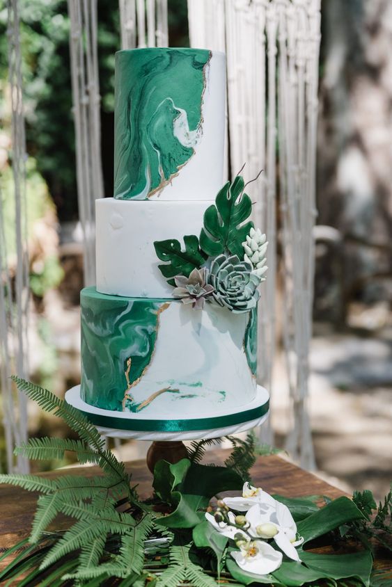 a green and white marble wedding cake with sugar blooms and succulents and gold touches is super elegant touch