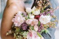 a lilac and pink wedding bouquet with greenery and a cool shape and texture for more interest
