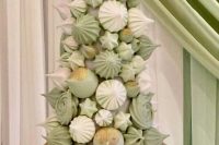 a lovely meringue tower of pastel green and white pieces is a gorgeous alternative to a usual wedding cake