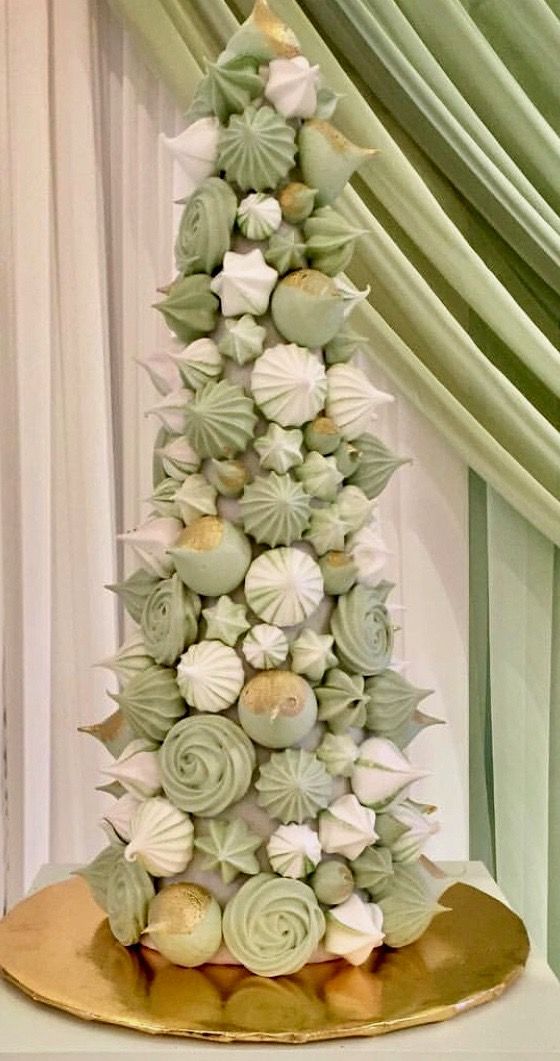 a lovely meringue tower of pastel green and white pieces is a gorgeous alternative to a usual wedding cake