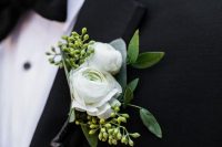 a lovely modern wedding boutonniere of white ranunculus and seeded euclayptus is a fresh touch to a chic modern groom’s look