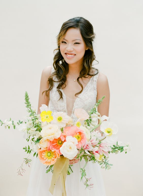 a lovely wedding bouquet of white, lemon yellow and tender pink blooms and greenery is a beautiful idea for a spring or summer bride