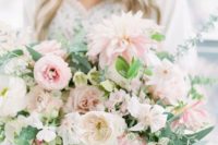 a lush and romantic pink wedding bouquet with greenery, with plenty of texture and a catchy shape