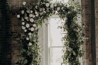 a lovely greenery wedding arch