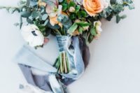 a marigold and white wedding bouquet with lots of eucalyptus and long velvet ribbons for spring