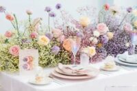 a modern and bright secret garden wedding table setting with a color block baby’s breath and rose runner, pastel place settings is amazing