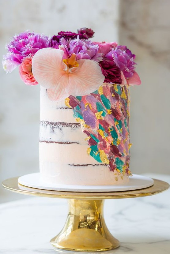a naked wedding cake with colorful dimensional brushstrokes and super bright blooms on top is a lively and fun idea