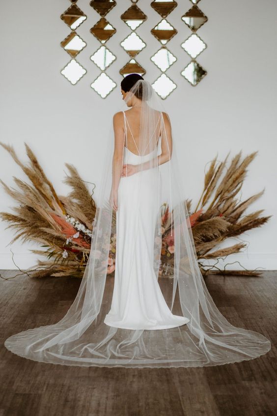 a one layer cathedral length wedding veil with scattered pearls and crystals is a beautiful and romantic take on classics
