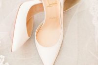 a pair of classic white bridal pumps, partly cut out will never go out of style and will match any bridal look
