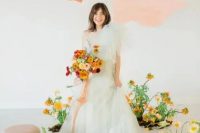 a pale green one shoulder wedding dress with layers of tulle on top is a delicate and chic idea for a spring or summer bride