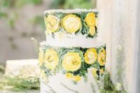 a refined and artistic wedding cake with painted yellow blooms and greenery for a spring or summer wedding