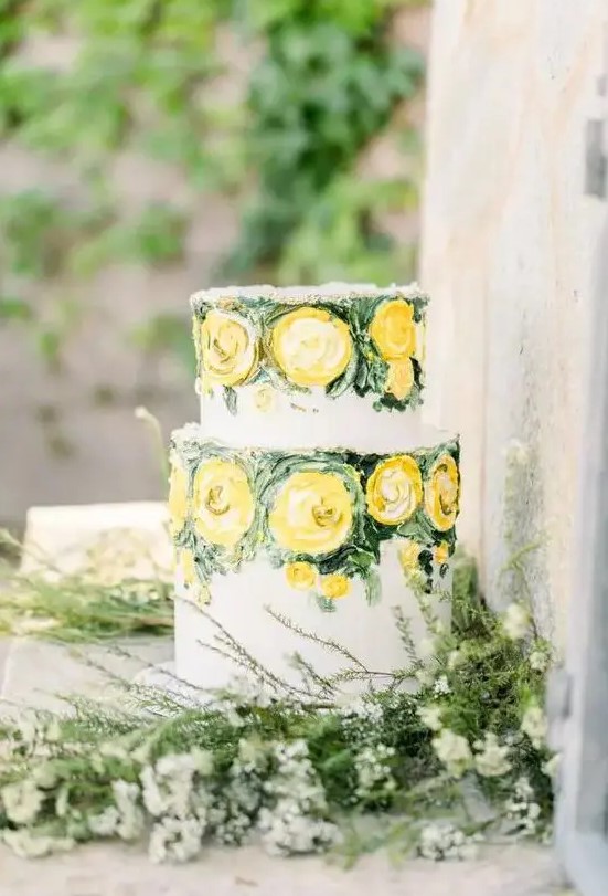 a refined and artistic wedding cake with painted yellow blooms and greenery for a spring or summer wedding