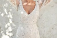 a refined glam fitting beaded wedding dress with a V-neckline and long sleeves is a gorgeous idea for a glam bride