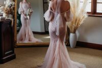 a refined off the shoulder blush mermaid wedding dress with puff sleeves and a train is a very chic and beautiful idea