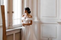 a refined off the shoulder plain A-line wedding dress with a pleated skirt and a train is amazing for a classic wedding